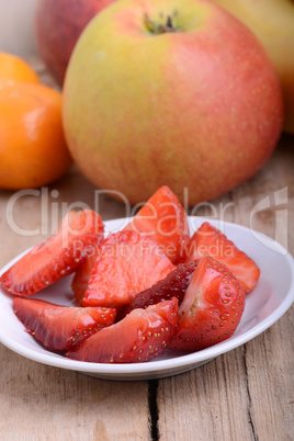 Strawberry slices and apple, mandarin and peach, closeup