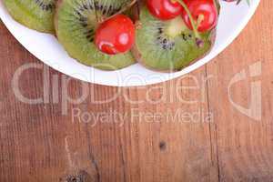 health fruit with cherry, kiwi slices on wooden plate