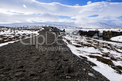 Tourists at the Icelandic waterfall Godafoss in wintertime