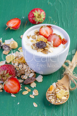 Yogurt with cereals muesli and fresh strawberries