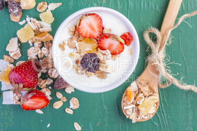 Yogurt with cereals muesli and fresh strawberries