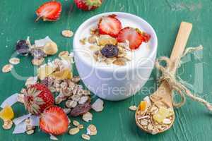 Yogurt with cereals muesli and fresh strawberries