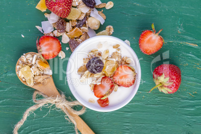 Yogurt with cereals muesli and fresh strawberries