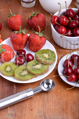 fruit with cherry, strawberry, kiwi on wooden plate