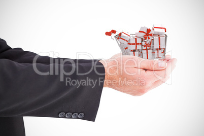 Composite image of businessman holding something with his hands