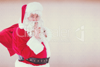 Composite image of santa keeping a secret and holding his sack