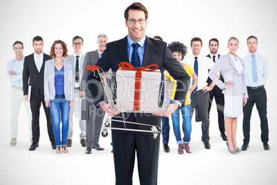 Composite image of businessman holding something with his hands