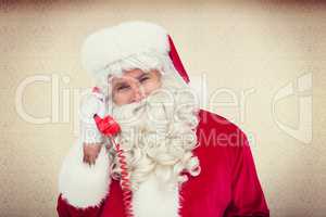 Composite image of santa claus on the phone