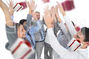 Composite image of business people raising their arms