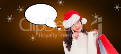 Composite image of festive brunette holding shopping bags and th