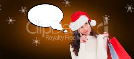 Composite image of festive brunette holding shopping bags and th