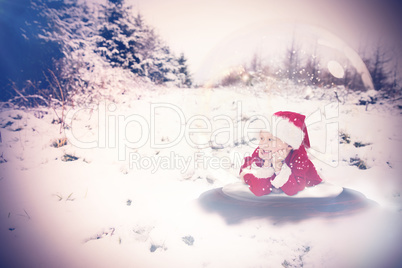 Composite image of festive child in snow globe