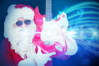 Composite image of cool santa showing electric guitar