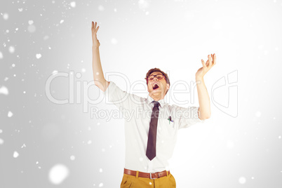 Composite image of geeky businessman standing with arms raised