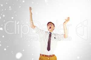 Composite image of geeky businessman standing with arms raised