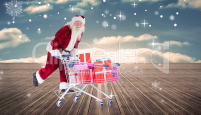 Composite image of santa pushing shopping cart