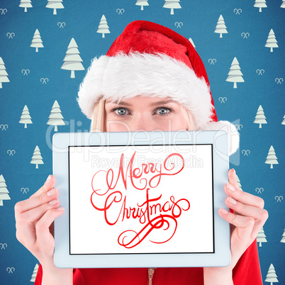 Composite image of festive blonde holding a tablet pc