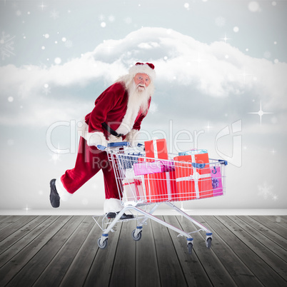 Composite image of santa pushing shopping cart