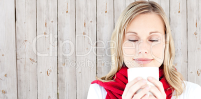 Composite image of portrait of a young woman enjoying her hot co