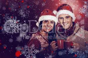 Composite image of young festive couple holding mugs