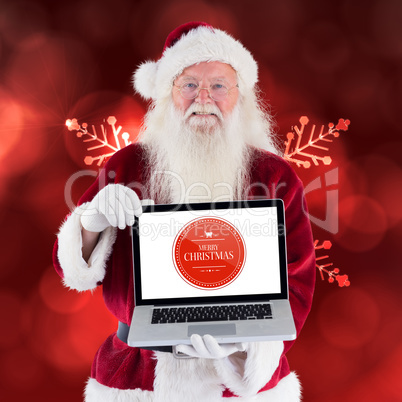 Composite image of santa claus presents a laptop