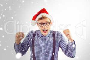 Composite image of geeky hipster wearing santa hat