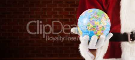 Composite image of santa has a globe in his hand