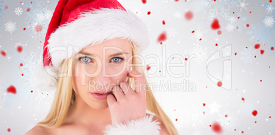 Composite image of festive blonde looking at camera