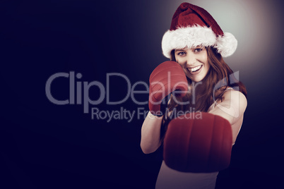 Festive redhead punching with boxing gloves