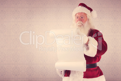 Composite image of santa claus reads a list