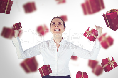 Composite image of successful businesswoman with clenched fists