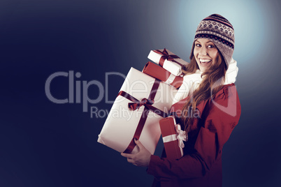 Pretty redhead in warm clothing holding gifts