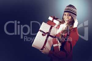 Pretty redhead in warm clothing holding gifts