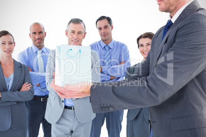 Composite image of businessman holding his hands out