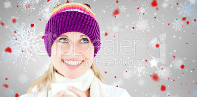 Composite image of smiling woman with a colorful hat and a cup i