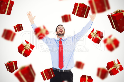 Composite image of happy cheering businessman raising his arms