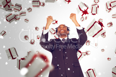 Composite image of happy businessman with raised arms