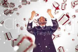 Composite image of happy businessman with raised arms