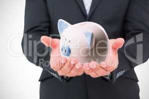 Composite image of businessman holding his hands out