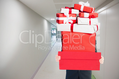 Composite image of businessman holding something with his hands