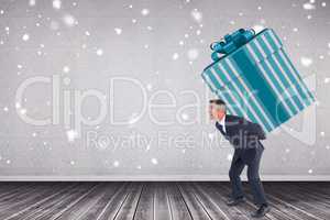 Composite image of stylish man with giant gift