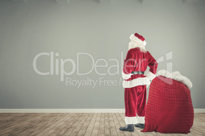 Composite image of happy santa with sack of gifts