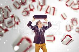 Composite image of young geeky businessman holding briefcase