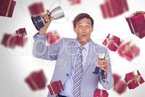 Composite image of portrait of successful businessman holding tr