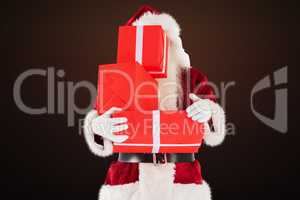 Composite image of santa covers his face with presents