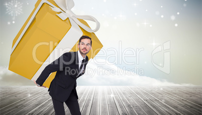 Composite image of stylish man with giant gift