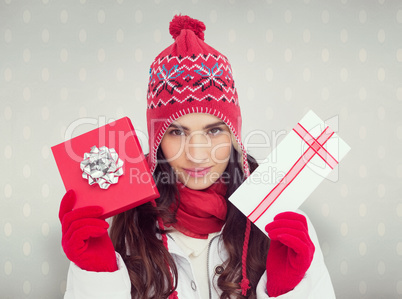 Composite image of festive brunette in winter clothes showing gi