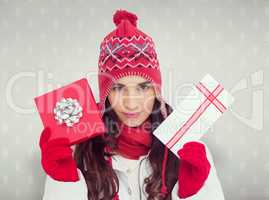 Composite image of festive brunette in winter clothes showing gi