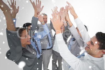 Composite image of business people raising their arms