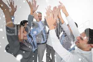 Composite image of business people raising their arms